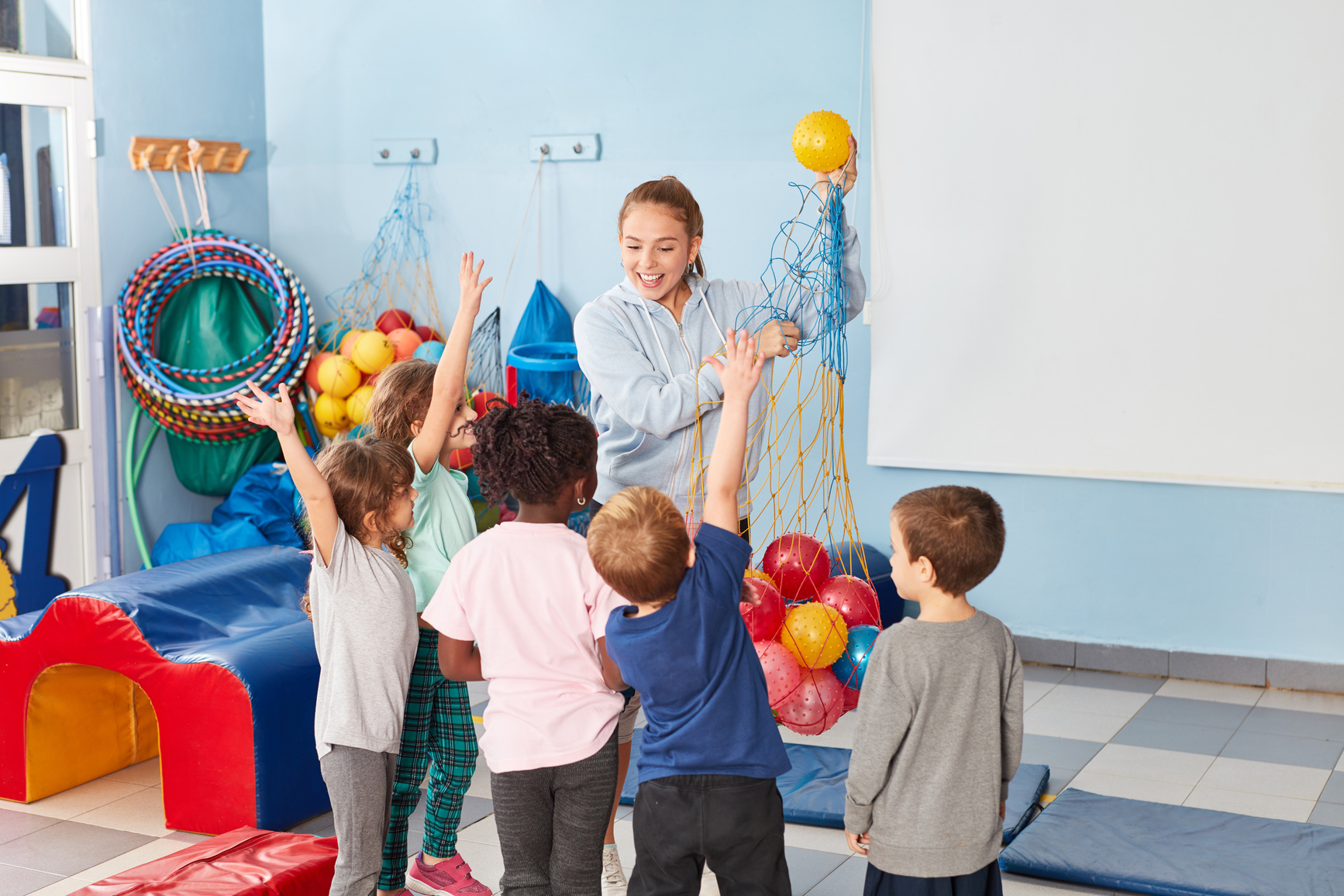 Sports Teacher and Children in the Gym